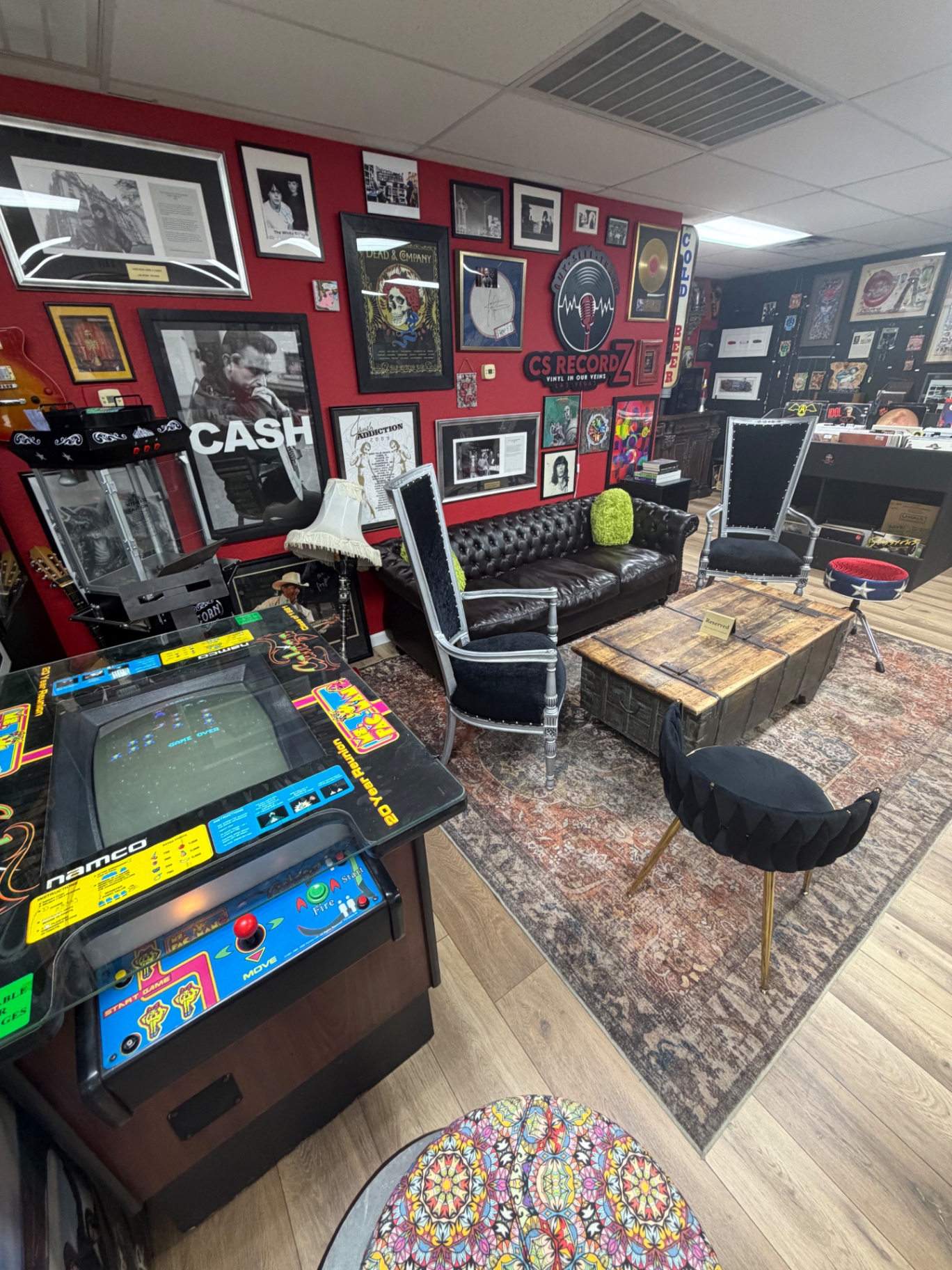 CS Recordz lounge area with arcade games, chesterfield sofa, and music memorabilia